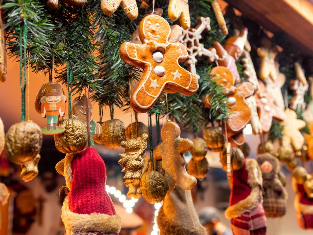 The image shows hanging Christmas decorations including baubles, gingerbread figures, and a nutcracker. 