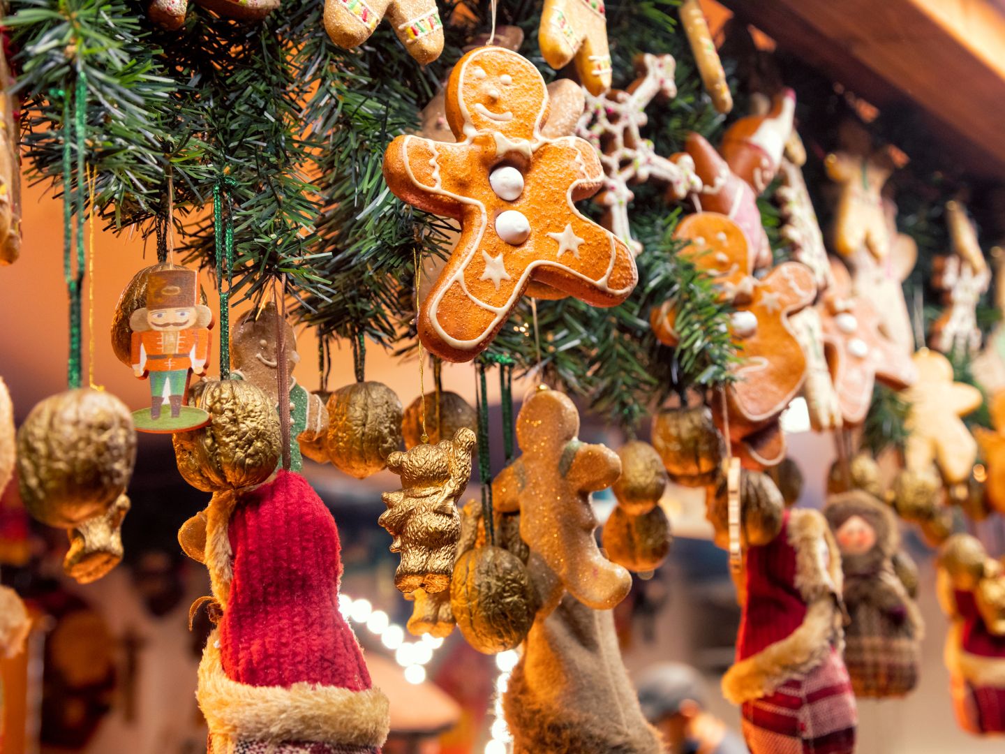 The image shows hanging Christmas decorations including baubles, gingerbread figures, and a nutcracker. 