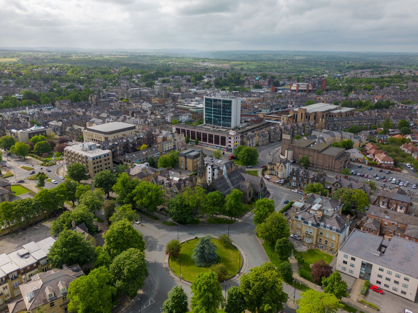 A view of Harrogate taken from high up. The image shows buildings, leafy trees and roads. 